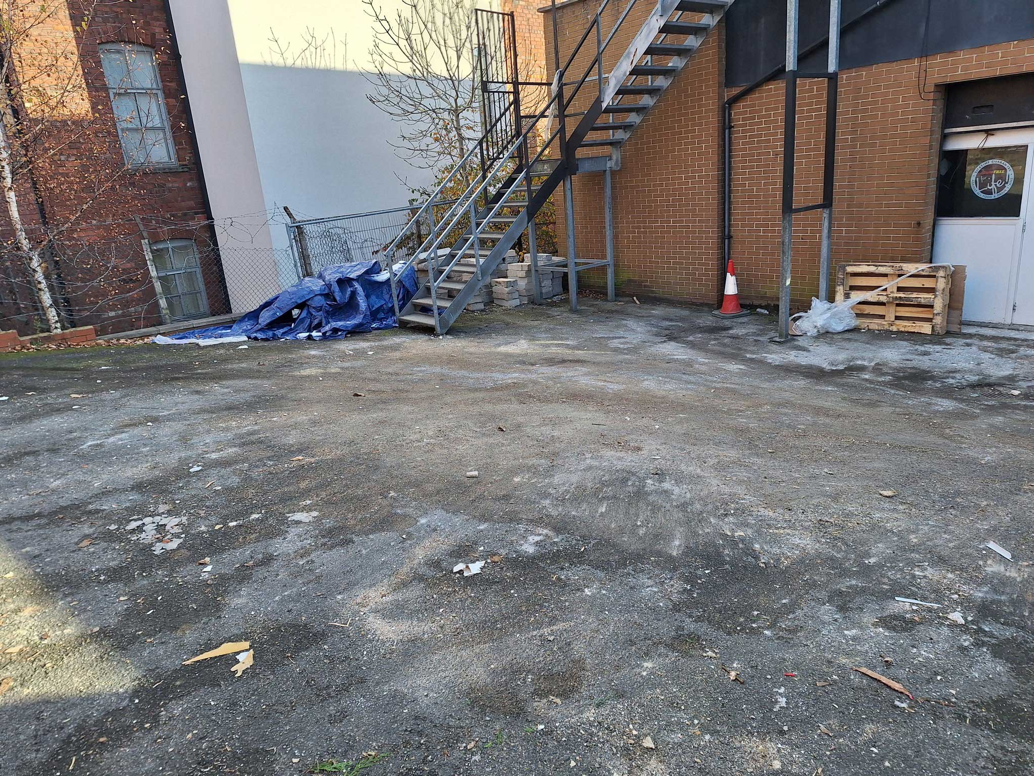 commercial ground is cleared from rubbish by waste removal team