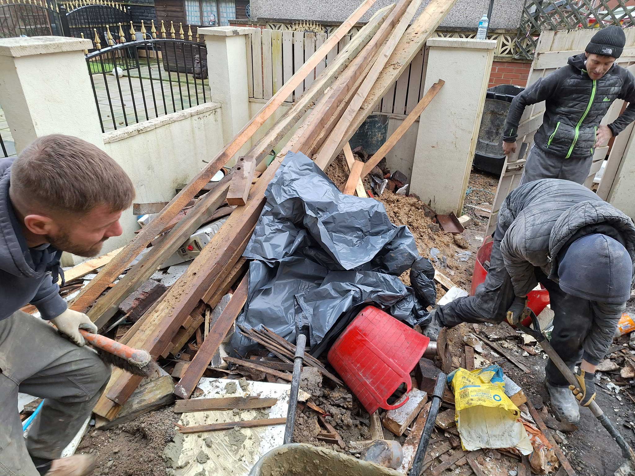 messy front garden commercial sand planks