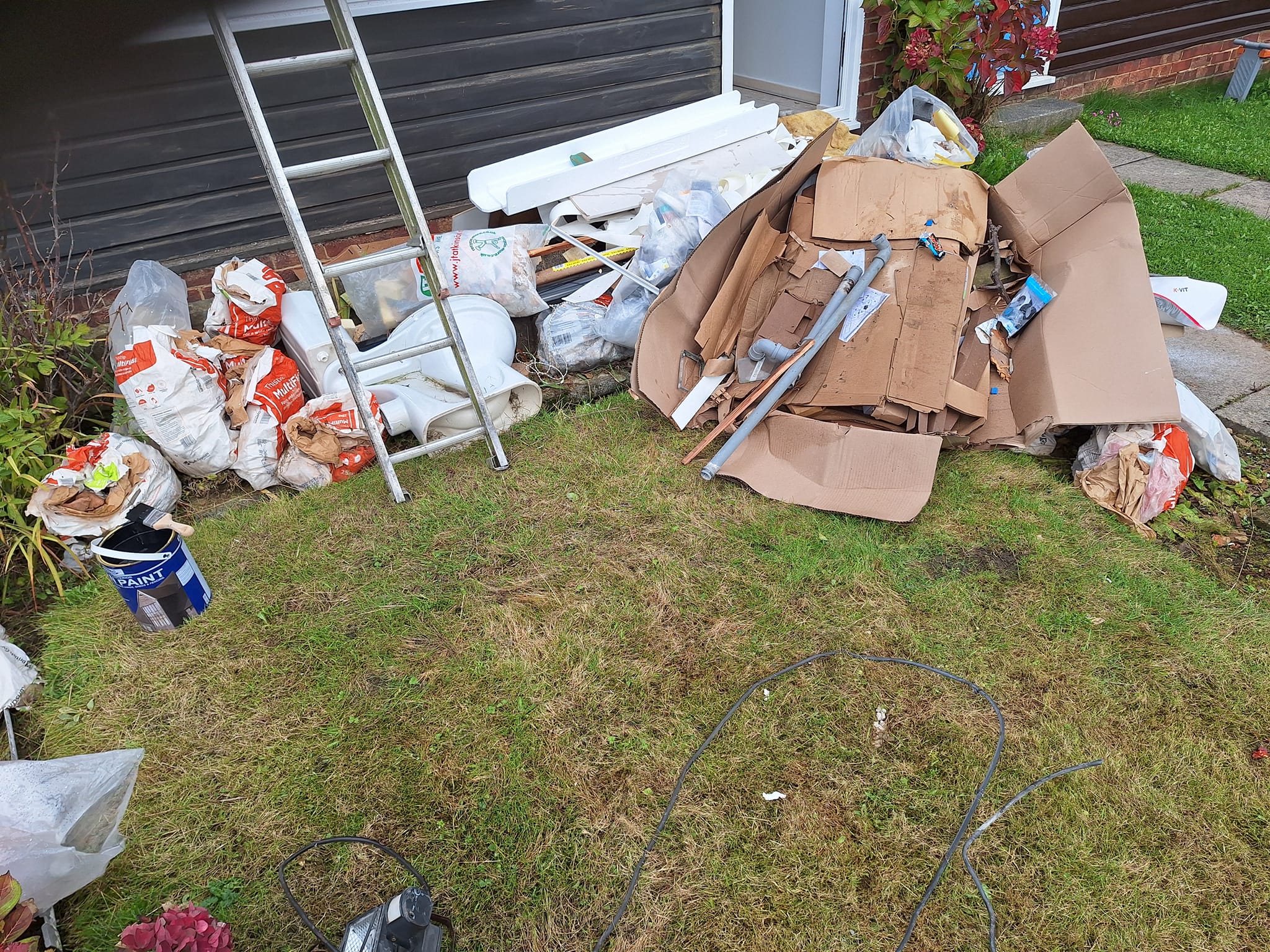 garden filled with rubbish toilet cardboard