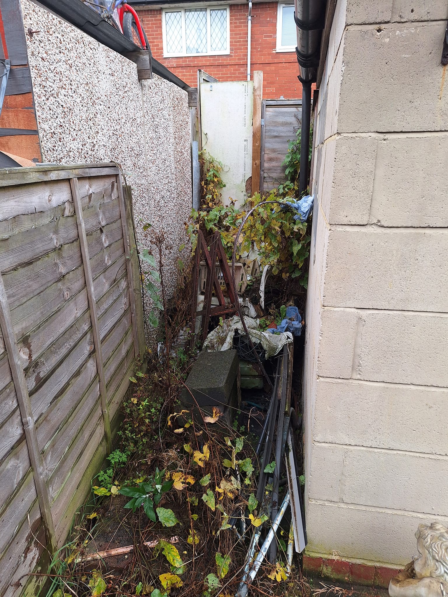 home alleyway filled with rubble and rubbish